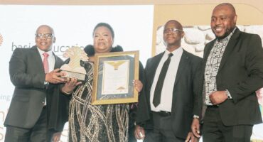 Image of the Dannhauser Primary principal receiving a certificate from national education officials.