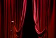 Image of red curtains parted on a stage.