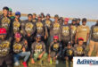 A group photo of an angling club posing at the dam during a compitition.