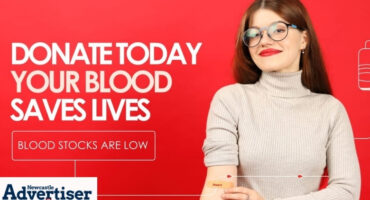 An image of a woman donating blood in front of a red background with bold white text.