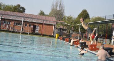 Image of a man diving into a pool.