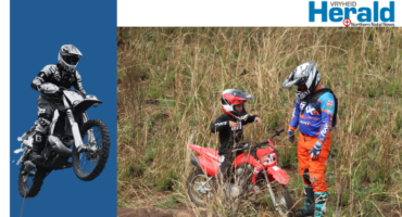 Image of an adult helping a younger motorbike rider.