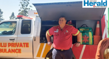 Image of a paramedic in front of an emergency vehicle.