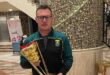 Photo of SA hockey men's under 21 coach Guy Elliott holding a trophy.