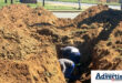 Workers photographed fixing a pipeline under ground.