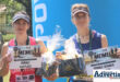 Two women holding their prizes and medals after completing the Memel to Newcastle Walk/Run.