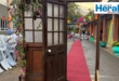 Image of a free-standing door leading to a red carpet.