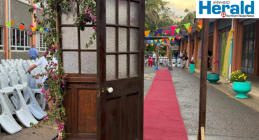 Image of a free-standing door leading to a red carpet.