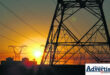 A photo of a power substation during sunrise.