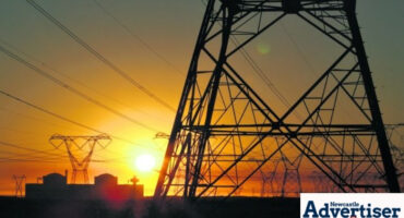 A photo of a power substation during sunrise.