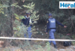 Image of two police officers in a cordoned-off area.