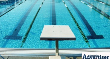 A photo of a clear-blue swimming pool.