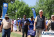 A photograph of several people including those dressesin DA regalia during a community protest.