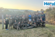 Image of a group of learners covered in mud.