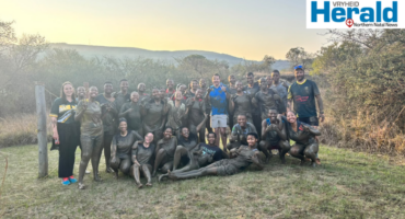 Image of a group of learners covered in mud.