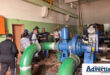 A photo of a group of people at a water pump at a water pump station in Newcastle.