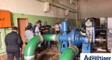 A photo of a group of people at a water pump at a water pump station in Newcastle.