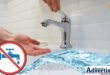 A tap without water in the backgrounjd with hands waiting for the water. A water strip and the Newcastlle Advertsier logo is at the bottom nd accros the picture. A white, red and blue no water warning is also seen.