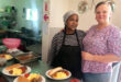 Roz Habgood with assistance, Thandaz, juggling menus in the kitchen.