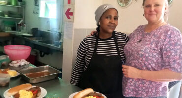 Roz Habgood with assistance, Thandaz, juggling menus in the kitchen.
