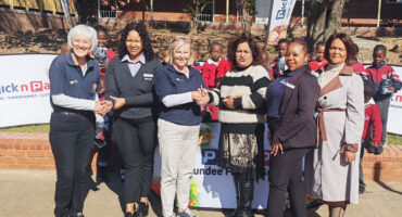 Image of Rotary Club members presenting shoes to a deserving school.