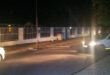 Image of a street light lying on the ground with security officials parked nearby.