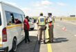 Image of uniformed traffic officers checking vehicles.