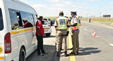 Image of uniformed traffic officers checking vehicles.