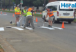 Image of people painting road markings in a street.