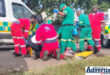 A group of paramedics at a scene treating an injured patient.