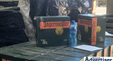 Boxes of alcohol stacked during a police raid.