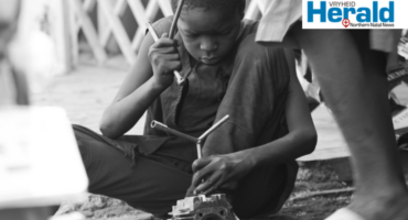 Image of a young African boy building a wire car, Pexels image.