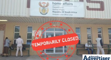 A photo of the Newcastle Home Affairs Building, with a big red closed sighn over it.