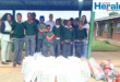 A group image of MMG Ford representative with Inkanyiso Special School staff members and leaners as non-perishable items were donated to the school.