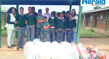 A group image of MMG Ford representative with Inkanyiso Special School staff members and leaners as non-perishable items were donated to the school.