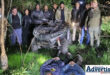 A group of crime fighters standing behind a stolen quad bike, while the two criminals lay face down on the ground in front of them.