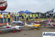 Several men are photographed with their model aircraft on the Newcastle Airstrip.