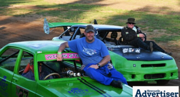Two oval track racers are photographed sitting on the bonets of their racing cars.