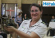 Image of a female honorary officer holding an owl.