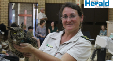 Image of a female honorary officer holding an owl.