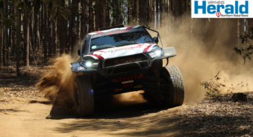 Image of a rally car racing.