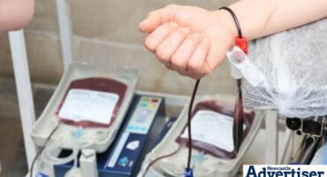 An image of an arm while donating blood in a blood bank.