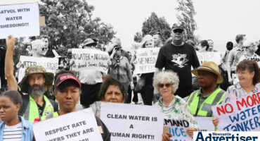 Newcastle West residents during a march in Newcastle brandishing posters.