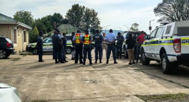 Image of a group of police officers huddled together.