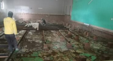Image of renovations being done to an old building in Dundee and removing wooden floor boards.
