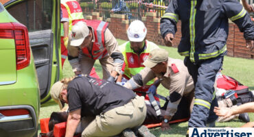 Various emergency services participating in World Trauma Day simulations at Mediclinic Newcastle, including ambulance services and firefighters.