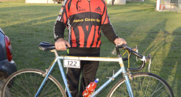 Image of a senior cyclist next to his bicycle in Dundee.