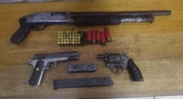 Image of three firearms and ammunition.