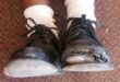 Image of two battered school shoes worn by a child.