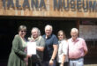 Group of people outside Talana Museum holding an Eskom account.